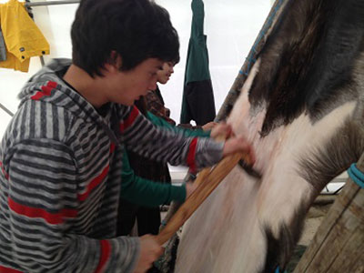 Participant in Ida Tremblay's hide-making workshop