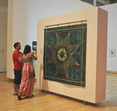 Visitors to the Kamloops Art Gallery view Star Blanket as part of the exhibition AlterNation, taking place from July 15 to September 9, 2017