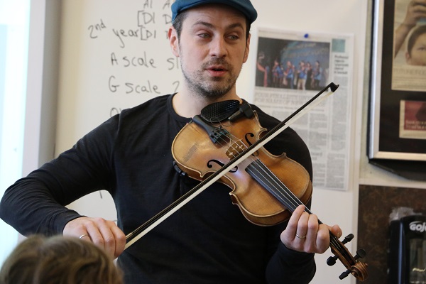 Karrnnel Sawitsky teaches students at St. Michael Community School the fiddle