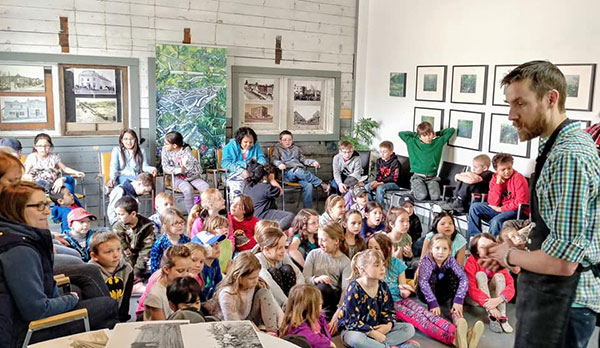 Artist Geoff Phillips speaks to Sidney Street School students about the art associated with the printing of posters at the turn of the last century encouraging settlers to homestead in the Canadian west