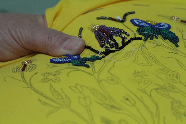 Doreen Roman at work on a beaded vamp