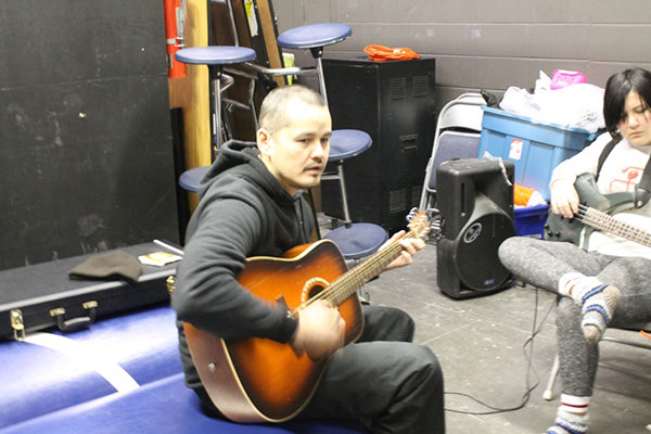 Damien Cheecham teaches students guitar at Dene High School in La Loche