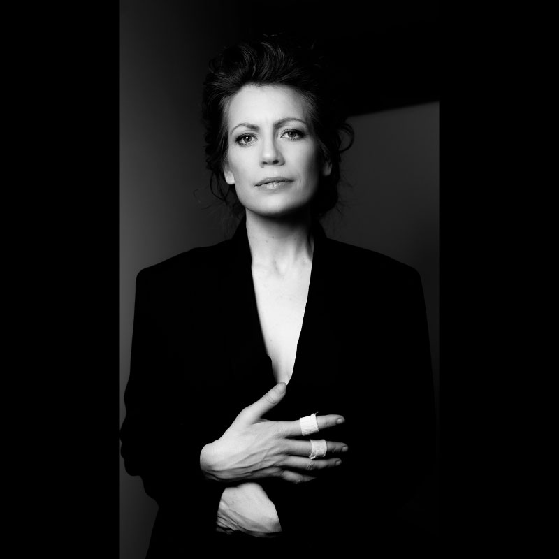Melanie Berglund - Woman in portrait photo with knuckles bandaged. She is wearing black jacket.