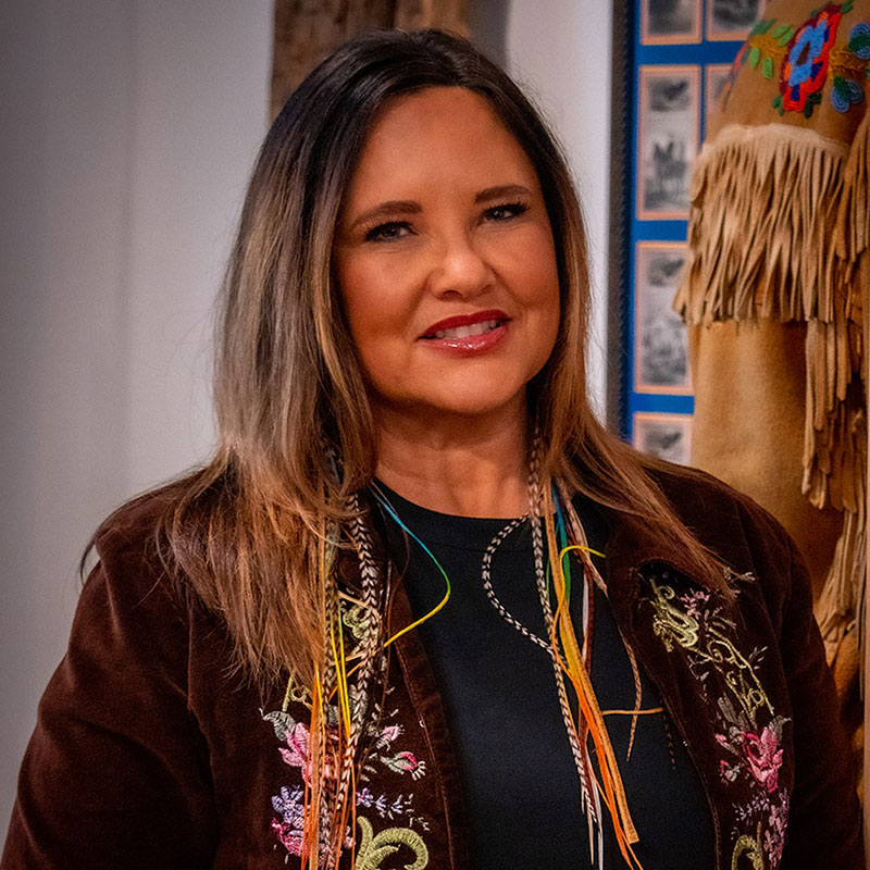Lisa Bird-Wilson - Portrait of Indigenous woman with black and blonde ombre hair smiling