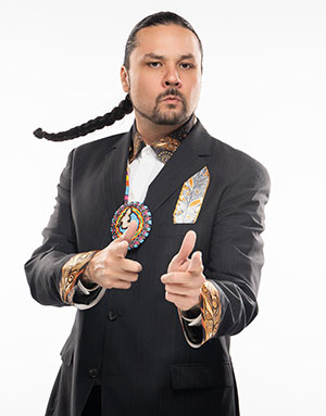 Shawn Cuthand by Ali Mehdi for SK Arts Arts of Celebration 2025. Headshot of Indigenous man in traditional wear and single long braid in his hair.