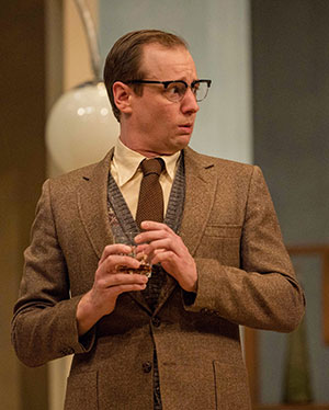 Tim Bratton for SK Arts Arts for Celebration 2025. White man wearing brown suit mid theatre performance.