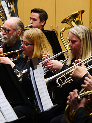 Warman Community band by Linley Redford for SK Arts Arts of Celebration 2025. Photos of on band members on stage playing musical instruments.