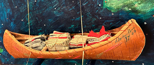 Indigenous Canadian Artist Sheila Orr - Artwork titled Returning Tainted Gifts, 1999 - A mixed media artwork showing a canoe stacked with blankets attached to painting of the sea