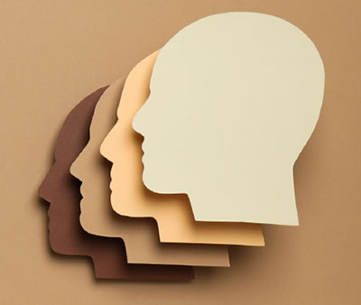 Picture of four monochromatic brown heads overlapping abstract head silhouettes on a background
